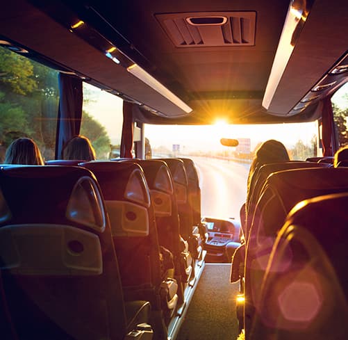 Interior of a charter bus at sunset